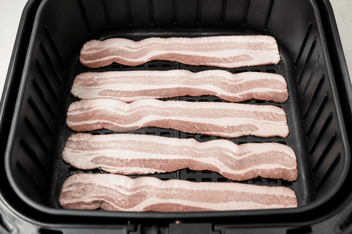 Bacon strips in a single layer in the air fryer basket
