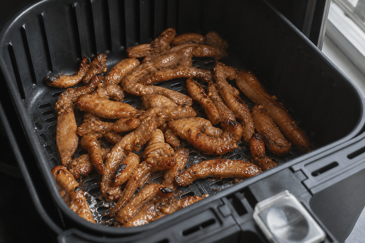 Lemongrass pork strips in a single layer in the air fryer
